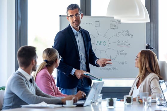 Businessman explaining a project to his colleagues on coworking place.