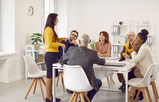 Team sitting around a table discussing AI and business.